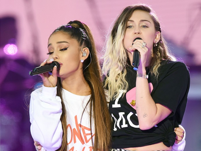 Ariana Grande (left) and Miley Cyrus perform at the One Love Manchester tribute concert in Manchester, north western England, Sunday, June 4. (Dave Hogan via AP)