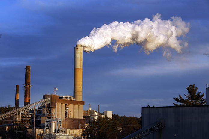 In this Jan. 20, 2015 file photo, a plume of steam billows from the coal-fired Merrimack Station in Bow, N.H. Earth is likely to hit more dangerous levels of warming even sooner if the U.S. pulls back from its pledge to cut carbon dioxide pollution because America contributes so much to rising temperatures, scientists said. (AP Photo/Jim Cole, File)