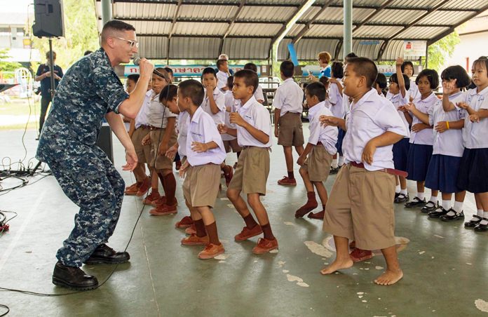 Musician Second Class Holden Moyer from the U.S. Navy’s 7th Fleet Band “Orient Express” sings to children at Ban Banglamung School as part of a community relations event CARAT 2017.