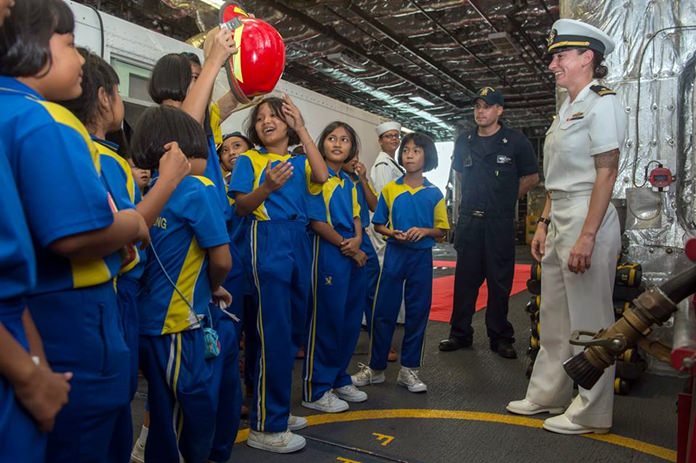 Sailors lead a tour for children from local schools aboard littoral combat ship USS Coronado (LCS 4) during Cooperation Afloat Readiness and Training (CARAT) Thailand.