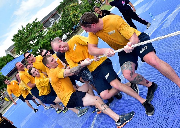 Sailors attached to USS Coronado (LCS 4) play tug-of-war with children from Banntunggard School during a community outreach event May 31. 