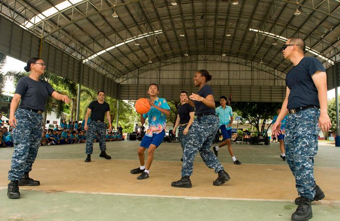 Sailors assigned to littoral combat ship USS Coronado (LCS 4) play basketball with children at Ban Banglamung School.