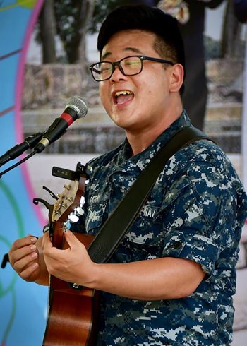 Navy Musician 2nd Class Daniel Park, of the U.S. 7th Fleet Band, Orient Express, performs at the Child Protection and Development Center in Chonburi, June 3. 