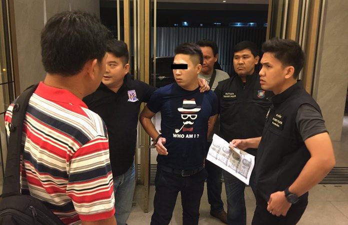 Li Wei Bin (center) is arrested for allegedly blackmailing a woman from his home country with a sex tape.