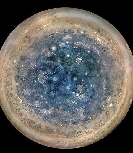 This image made available by NASA on Thursday, May 25, 2017, and made from data captured by the Juno spacecraft shows Jupiter’s south pole. The oval features are cyclones, up to 600 miles (1,000 kilometers) in diameter. (NASA/JPL-Caltech/SwRI/MSSS/Betsy Asher Hall/Gervasio Robles via AP)