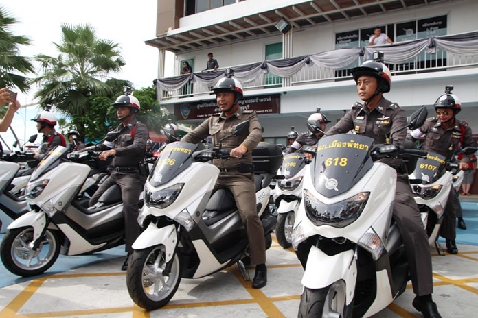 Pol. Col. Apichai Kroppech (center) takes possession of 37 new motorcycles for police use.