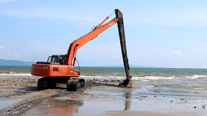 The contractors are now using excavators to dig up and spread dark sand on shore so that it can dry and let nature take its course in cleansing it.
