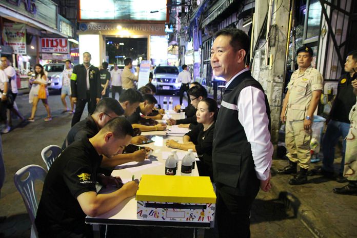 District Chief Naris Niramaiwong manned a booth set up from 9 p.m. to midnight June 20 to have vendors and other nighttime workers complete the prime minister’s questionnaire on politics and the future of Thailand.