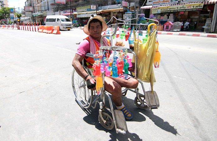 Every day Wiwat Waanproh can be seen in his wheelchair selling key chains to earn extra income for his family.