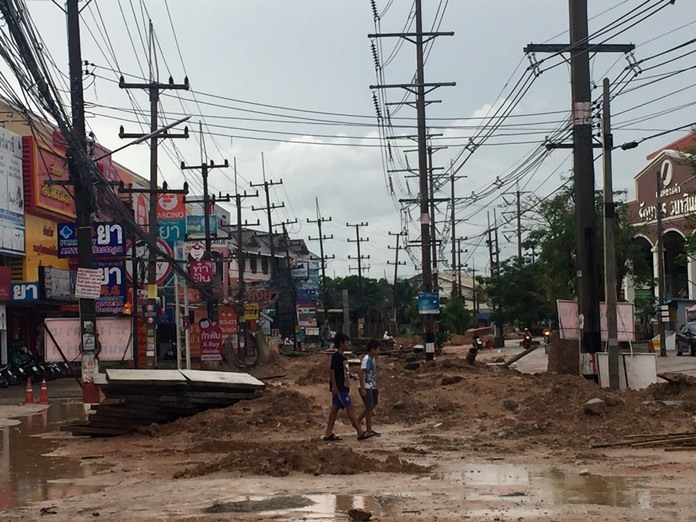 Soi Siam Country Club residents thought they had it bad before, but the street, already in shambles due to long-delayed reconstruction, became a mud-wrestling venue July 11 after heavy storms hit Pattaya.