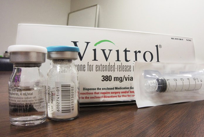 This Oct. 19, 2016, file photo shows the packaging of Vivitrol at an addiction treatment center in Joliet, Ill. A new study finds only 1 in 4 teens and young adults with opioid addiction receive recommended treatment medication despite having good health insurance. (AP Photo/Carla K. Johnson, File)