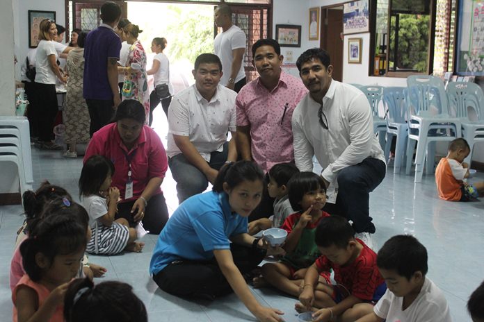 (Kneeling L to R) Chalermpol, Nakhon and Sakon Phonlookin celebrate their birthdays by throwing a party with the children of the Fountain of Life Center.