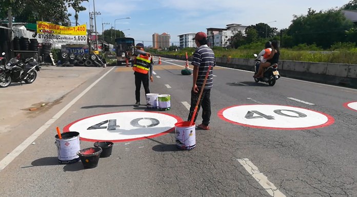Pattaya workers painted warning signs and speed limits on the railway parallel road to reduce accidents.