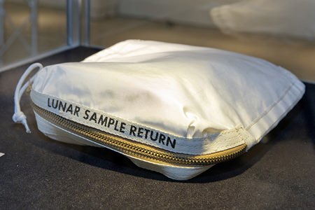 The Apollo 11 Contingency Lunar Sample Return Bag used by astronaut Neil Armstrong sold for $1.8 million at an auction on Thursday following a galactic court battle. The lunar dust plus some tiny rocks that Armstrong also collected are zipped up in a small bag. (AP Photo/Richard Drew)