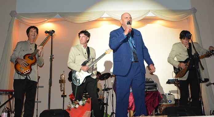 Event organizer Tom Coghlan introduces the first set by the Beatles Tribute act.