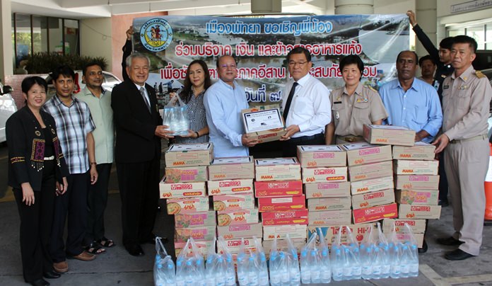 Bangladesh Association of Pattaya President Jahangir Hossain presents donated drinking water and dried food to Pattaya Deputy Mayor Vichien Pongpanit to be passed on to agencies aiding victims in Kalasin, Maha Sarakham, Nakhon Ratchasima, Sakon Nakhon and Yasothon.