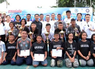 (Left) Trophy and certificate winners from the second Pattaya Windsurfing Tournament pose for a group photo at Jomtien Beach, August 6.