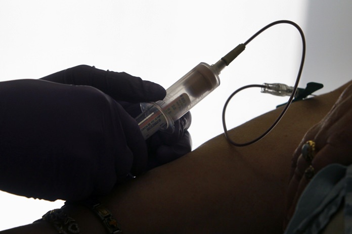 A patient has her blood drawn for a liquid biopsy during an appointment at a hospital in Philadelphia. Scientists have the first major evidence that such blood tests hold promise for screening people for cancer. (AP Photo/Jacqueline Larma, File)