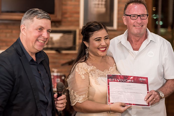 Roy Matthews from R&J asset management receives 1st prize; a 3 nights stay at the Amari in Phuket from Catherine Petit, Managing Director of FED Property Group.