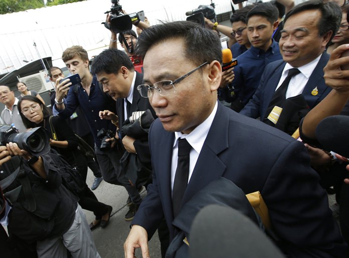 Former Prime Minister Yingluck Shinawatra's lawyer Norrawit Larlaeng denies knowledge of her whereabouts outside the Supreme Court, Friday, Aug. 25, 2017, in Bangkok. (AP Photo/Sakchai Lalit)