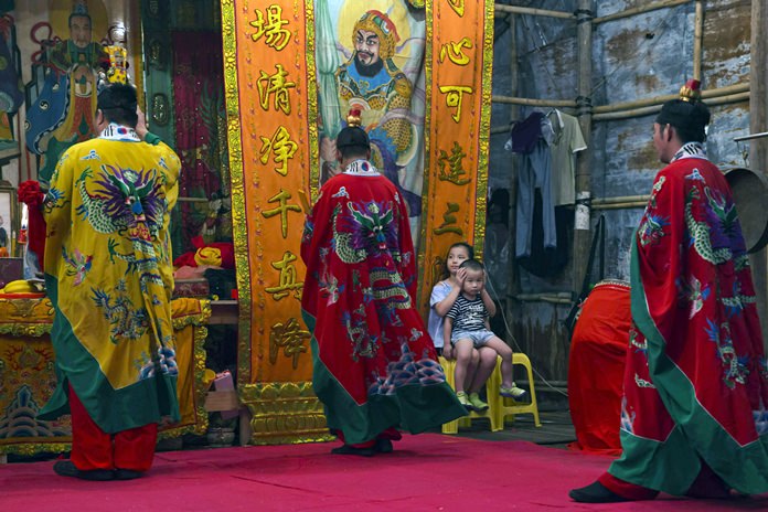 Taoists attend a service during the “Hungry Ghost Festival” in Hong Kong. (AP Photo/Kin Cheung)
