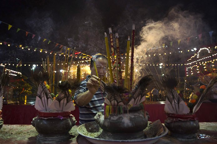 A worshiper burns incense during the “Hungry Ghost Festival” in Hong Kong. (AP Photo/Kin Cheung)