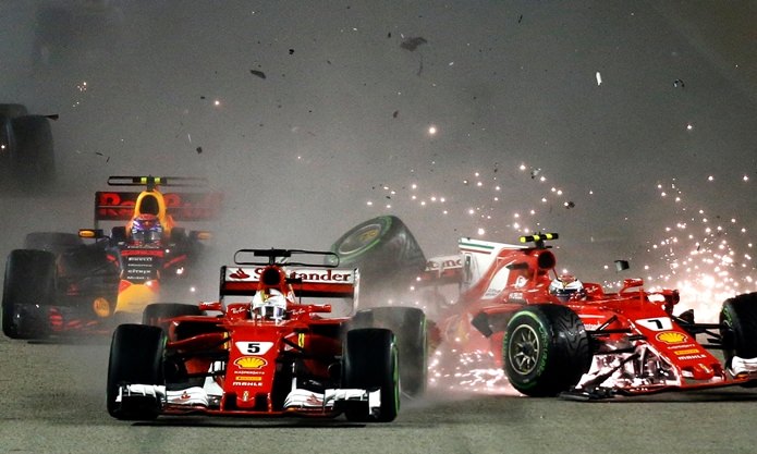 Ferrari driver Kimi Raikkonen (right) of Finland collides with teammate Sebastian Vettel of Germany at the start of the Singapore Formula One Grand Prix on the Marina Bay City Circuit Singapore, Sunday, Sept. 17. Vettel’s title rival, Lewis Hamilton of the Mercedes team, won the race to extend his championship lead.