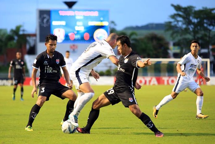 Pattaya United’s Serbian striker Milos Stojanovic (centre) fights for the ball with Navy defenders during the first half of the Thai Premier League game between Pattaya United and Siam Navy FC at the Sattahip Navy Stadium in Sattahip, Sunday, Sept. 17. 