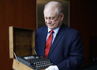 H. Keith Melton holds an Enigma Machine used in World War II to encode messages. (AP Photo/Jacquelyn Martin)