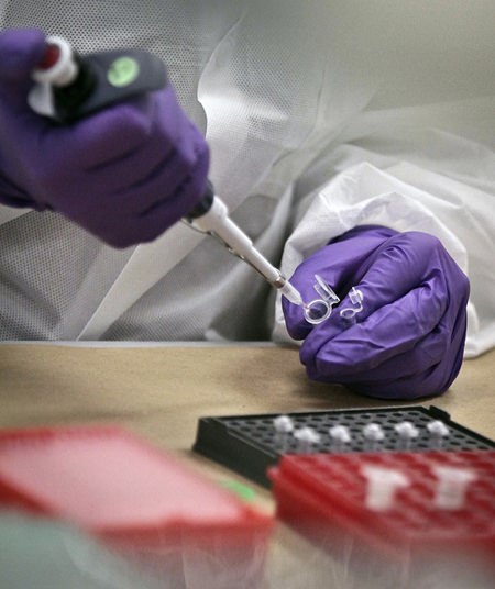 In this April 15, 2014 file photo, a criminalist trainee prepares sample bone fragments for DNA testing at the training lab in the Office of Chief Medical Examiner in New York. A technique for analyzing DNA evidence developed by the laboratory has come under fire amid questions about its reliability. (AP Photo/Bebeto Matthews, File)