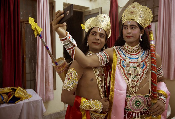 In this Thursday, Sept. 21, 2017 file photo, Indian artists dressed as Hindu god Rama, right, and his brother Lakshman take a selfie before performing a traditional Ramleela drama, narrating the life of Hindu God Rama, during Dussehra festivities in Allahabad, India. The Hindu festival of Dussehra commemorates the triumph of Lord Rama over the demon king Ravana, marking the victory of good over evil. (AP Photo/Rajesh Kumar Singh, File)