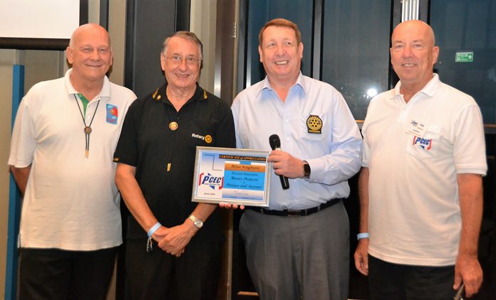 MC Roy Albiston poses with Rotary Club Eastern Seaboard members (l to r) Jan Abbink, Carl Dyson, and Brian Songhurst, after presenting them with the PCEC’s Certificate of Appreciation.