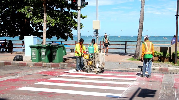 Pattaya workers repaint pedestrian crossings across Beach Road to prepare for high season.