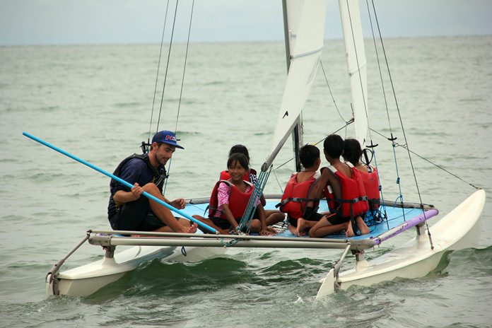 The children are taught how to sail.