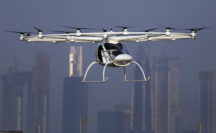 In this Sept. 26, 2017 photo, a Volocopter prototype flies in front of the city skyline during a test flight in Dubai, United Arab Emirates. Dubai is hoping to one day have flying, pilotless taxis darting among its skyscrapers. (AP Photo/Kamran Jebreili)