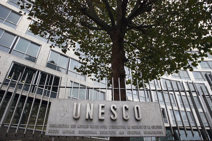 The United Nations Educational Scientific and Cultural Organization logo is pictured on the entrance at UNESCO’s headquarters in Paris, France. (AP Photo/Francois Mori, File)