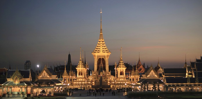Dusk light fades behind the warmly lit royal crematorium and funeral complex for HM the late King Bhumibol Adulyadej in Bangkok. King Bhumibol Adulyadej, who reigned for 70 years before his death on Oct. 13, 2016, is being honored in an elaborate royal funeral and cremation ceremony from Oct. 25 to 29. In this week’s edition, filled with emotion, we say a final goodbye to our most beloved monarch, our hearts filled with sorrow for his departure, but also filled with solemn joy, for deep down inside we know he has taken a place among the greats in heaven. (AP Photo/Wason Wanichakorn)