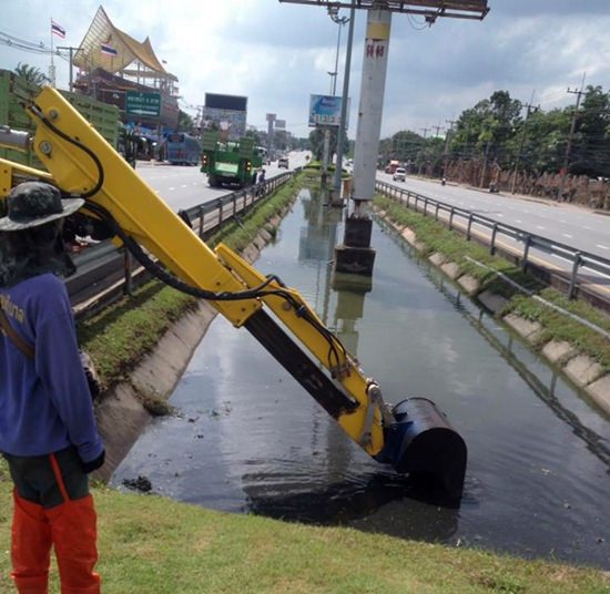 Pattaya dredged drainage canals dividing lanes on Sukhumvit Road to mitigate flooding.
