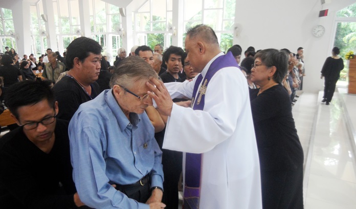 Fr. Corsie lays hands on those seeking a healing experience.
