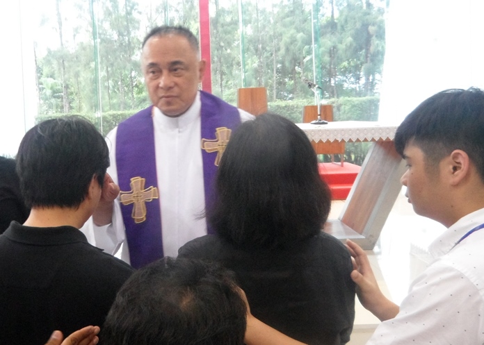 Devine Healer Fr. Corsie Legaspi enters the Assumption church.