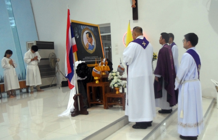 The resident and visiting priests hold a minute’s silence for King Rama IX.