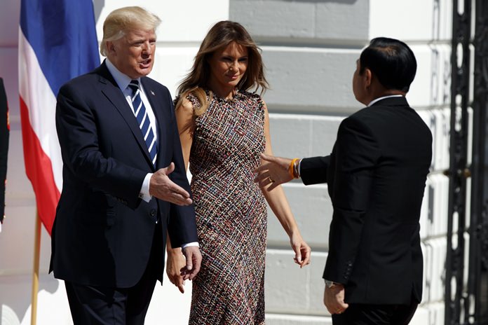 President Donald Trump and first lady Melania Trump greet Thai Prime Minister Prayuth Chan-ocha on the South Lawn of the White House, Monday, Oct. 2, 2017, in Washington. (AP Photo/Evan Vucci)