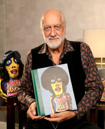 Mick Fleetwood poses with a copy of his book “Love That Burns - A Chronicle of Fleetwood Mac, Volume One: 1967-1974” during an interview in London. (AP Photo/Matt Dunham)