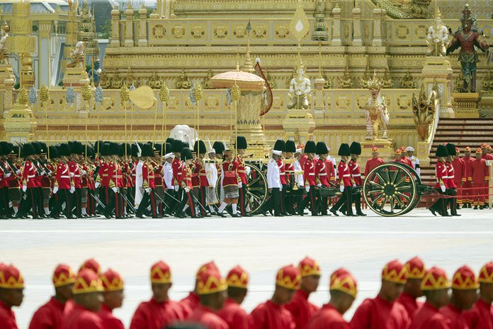The ceremonial urn of HM the late King Bhumibol Adulyadej arrives at the crematorium during the funeral procession as royal crematorium is seen in the background. (AP Photo/Wason Wanichakorn)