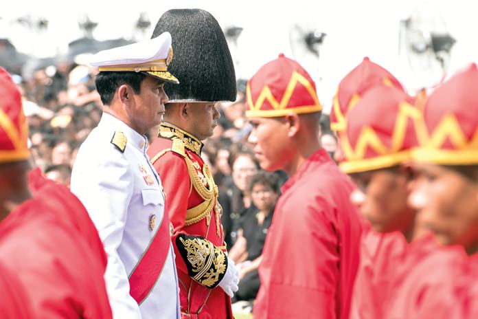 (Right) Prime Minister Prayuth Chan-ocha, left, participates at the funeral procession and royal cremation ceremony of late Thai King Bhumibol Adulyadej. (AP Photo/Kittinun Rodsupan)