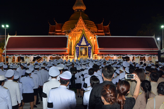 Officials in dress white uniforms and black armbands say their final goodbyes at Wat Chaimongkol.
