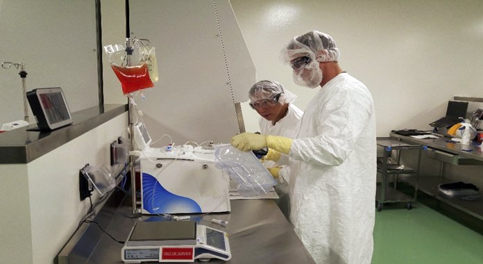 Cell therapy specialists at Kite Pharma’s manufacturing facility in El Segundo, Calif., prepare blood cells from a patient to be engineered in the lab to fight cancer. (Kite Pharma via AP, File)