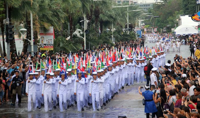 Thai sailors almost had to swim down Pattaya Beach Road through the floods as they carry flags from 40 different countries.