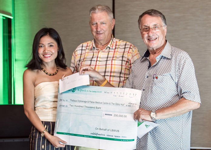 Joy (left) and Carl (right) from the RCES represented the Pakse Medical Centre in receiving a check for 200,000 baht.