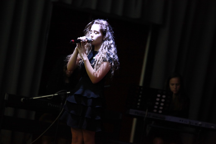 A Year 11 student sings at the whole-school assembly.